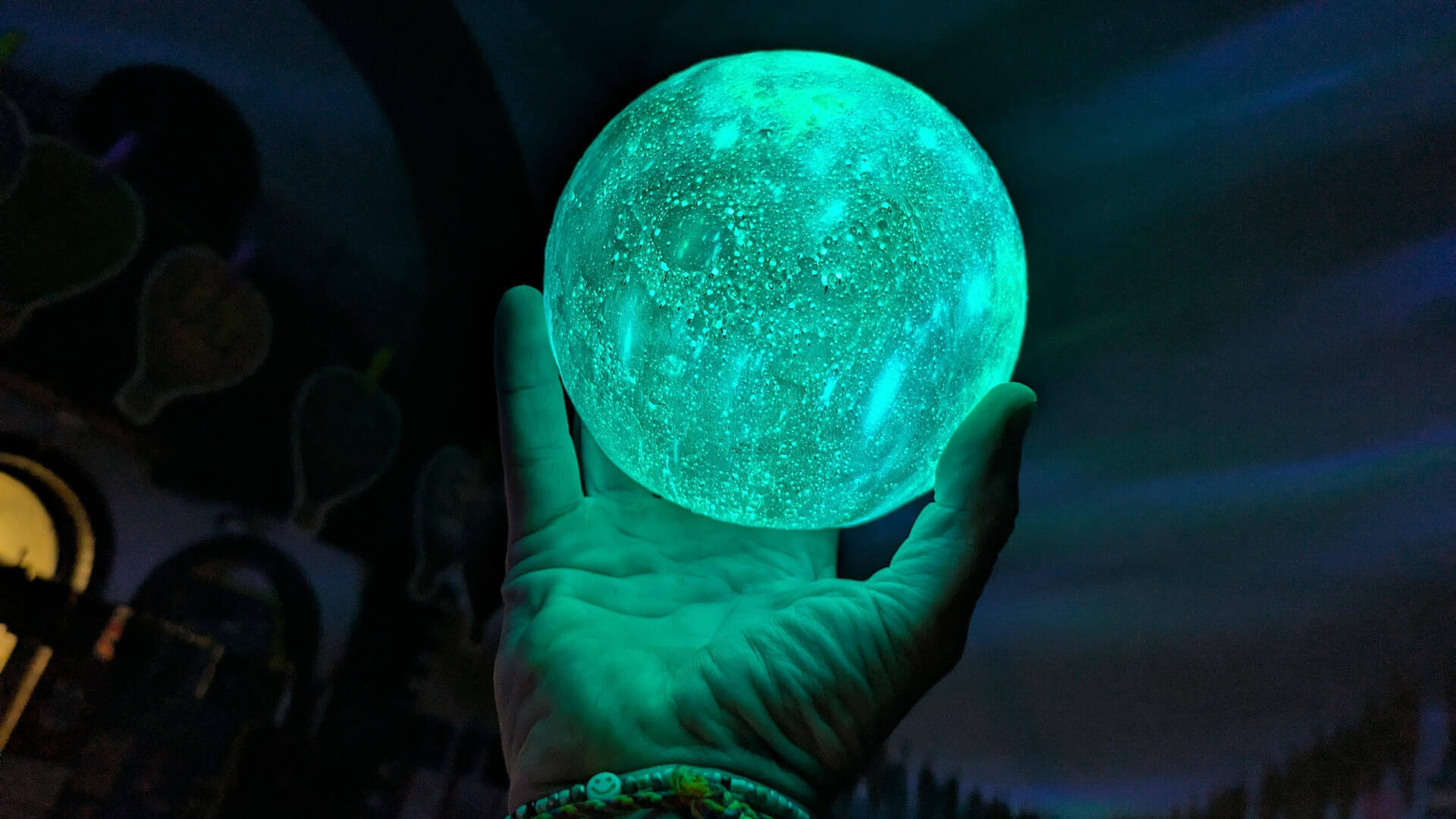 A man rejoicing at sunrise after a cold water dip in Wales